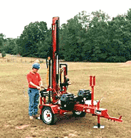 A small trailer-mounted drilling rig